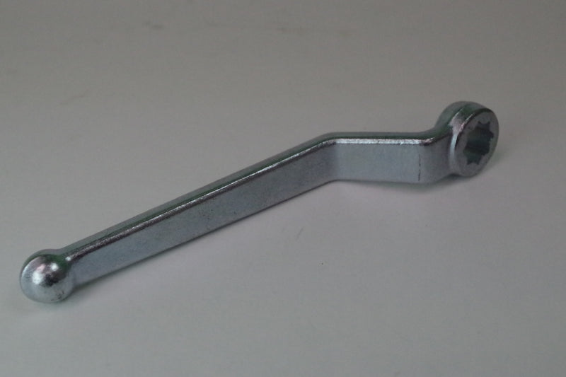 Metal wrench on a plain background