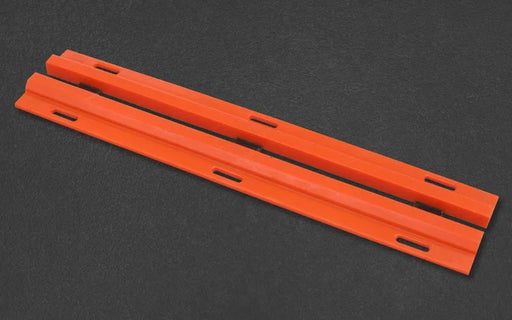 Two orange plastic strips on a black background